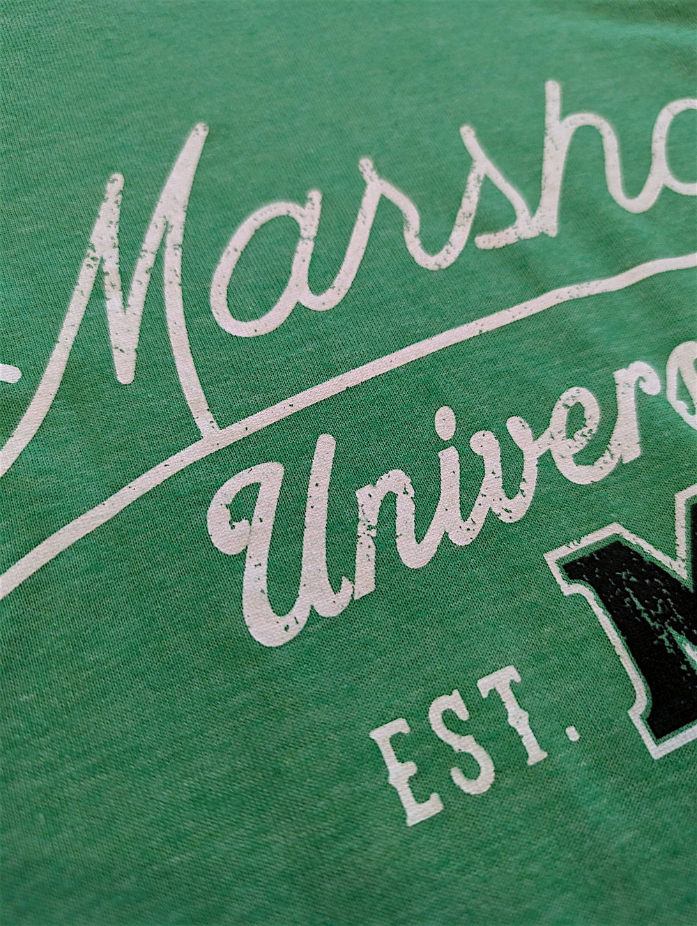 Green shirt with white and black text reading 'Marshall University EST.'