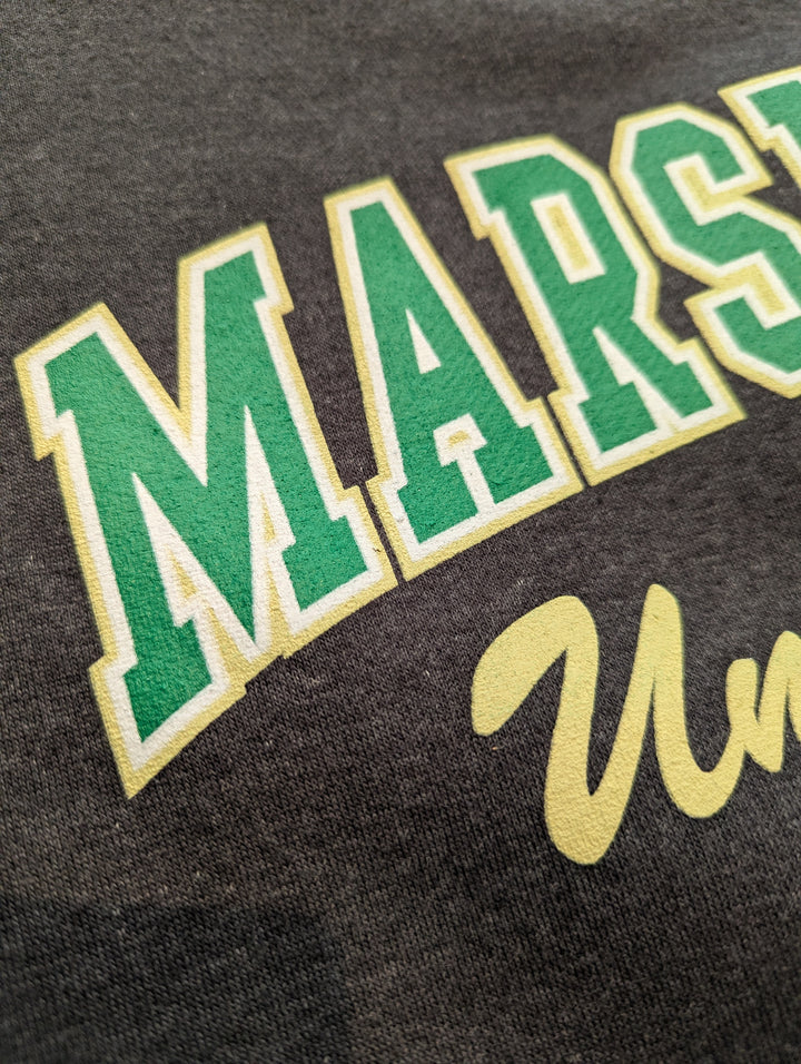 Close-up of a dark fabric with green and yellow text on a black background