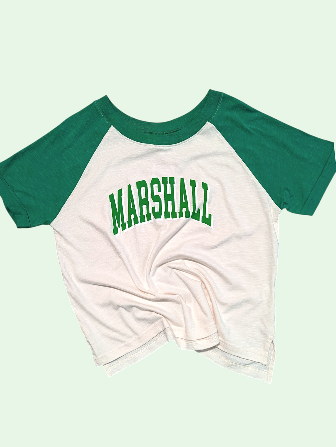 White t-shirt with green sleeves and 'MARSHALL' text on a light green background