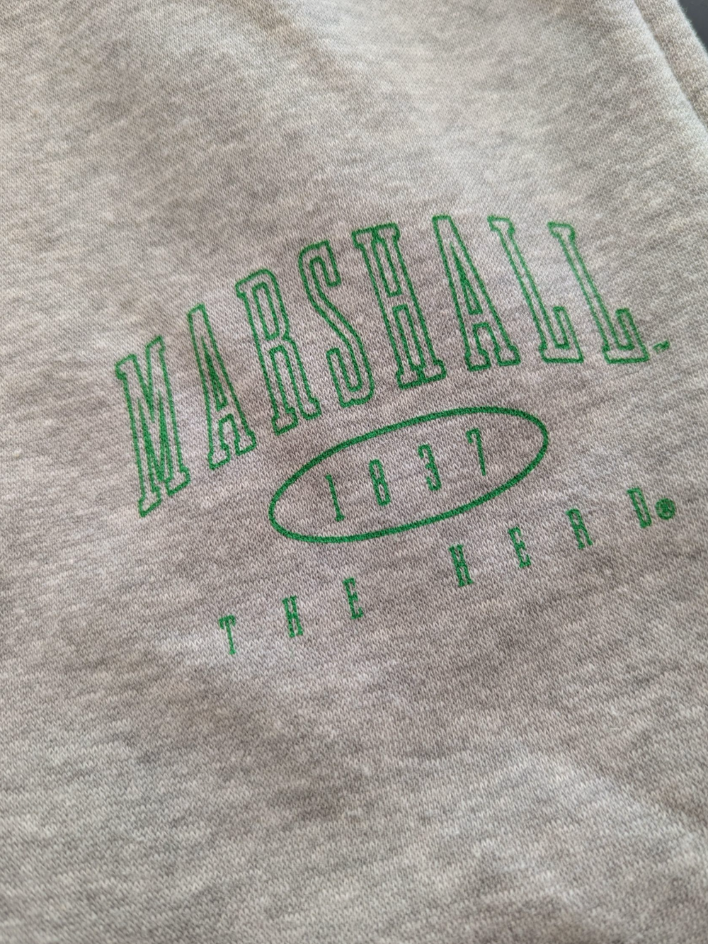 Gray sweatshirt with green 'Marshall 1837 The Herd' text on a close-up view