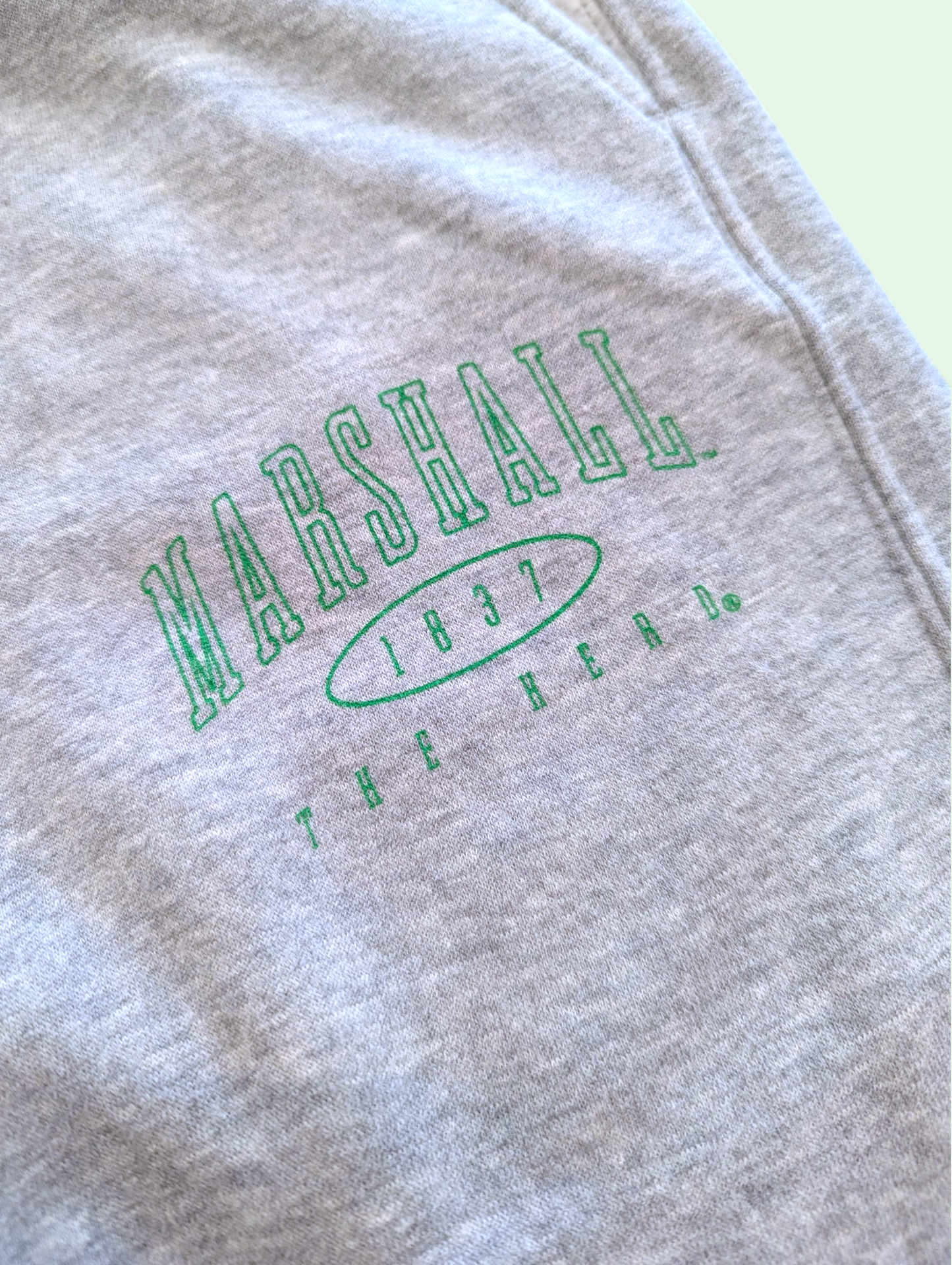 Gray sweatshirt with 'Marshall 1937 The Bear' text in green on a light background