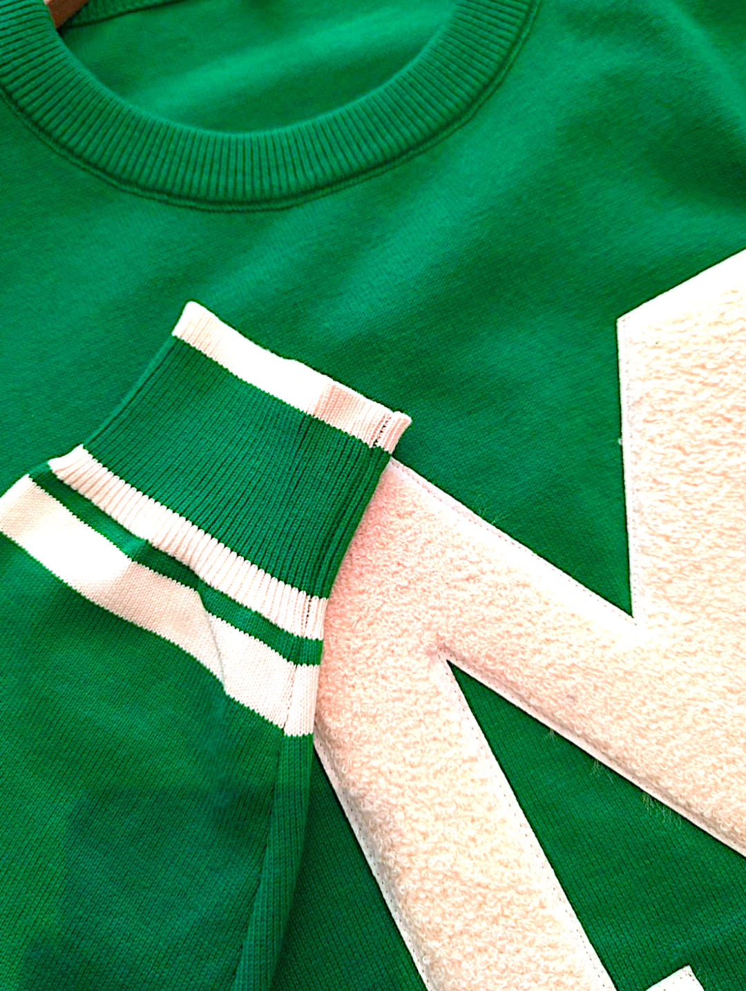 sleeve and letter detail of the cheer sweater