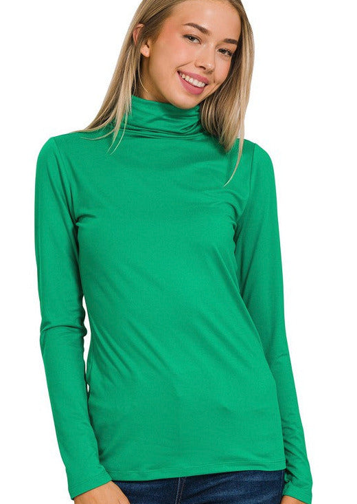 a blonde model stands with her hands to her sides showing us the mock neck top.