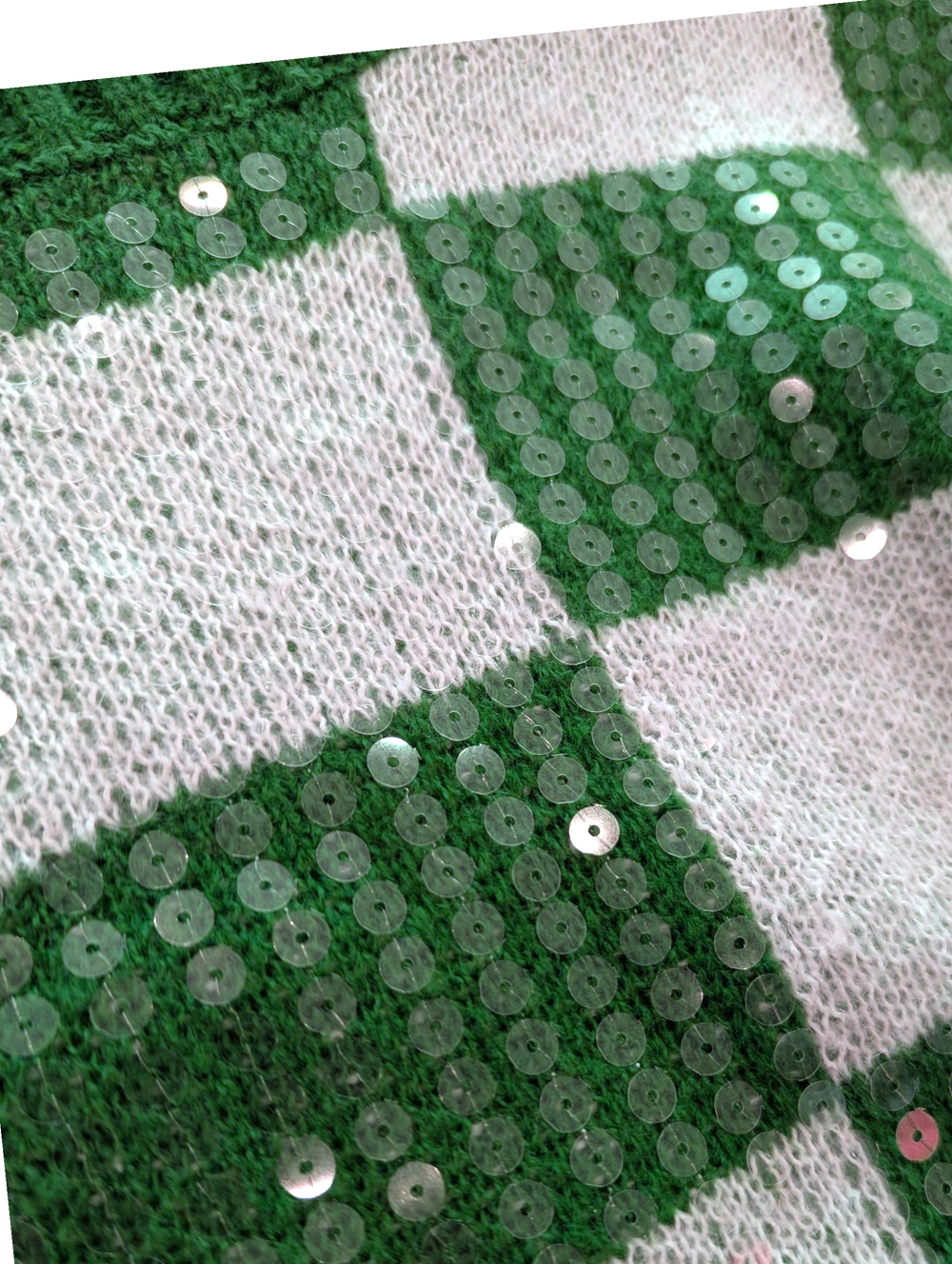 Close-up of a green and white checkered fabric with sequins.