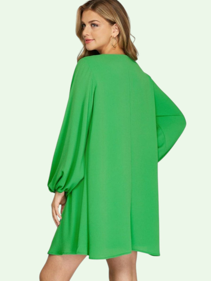 Green dress worn by a model on a white background