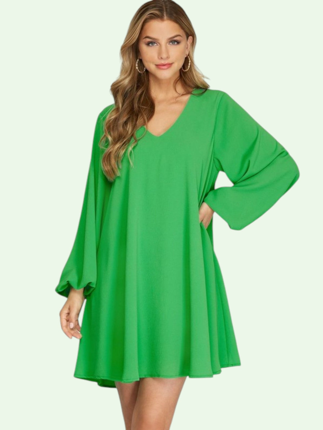 Woman wearing a green dress on a white background