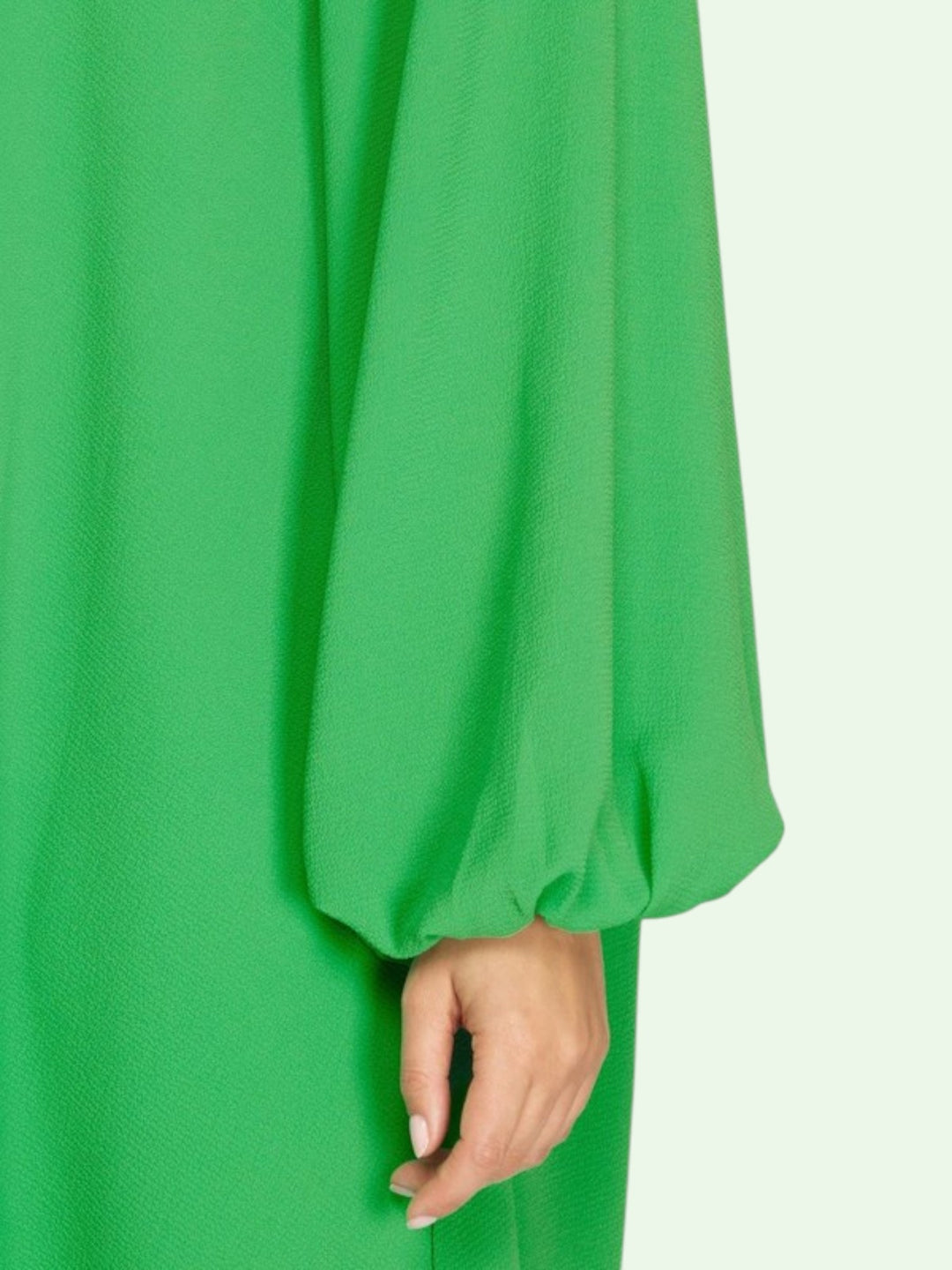 Green dress with long sleeves and a white background