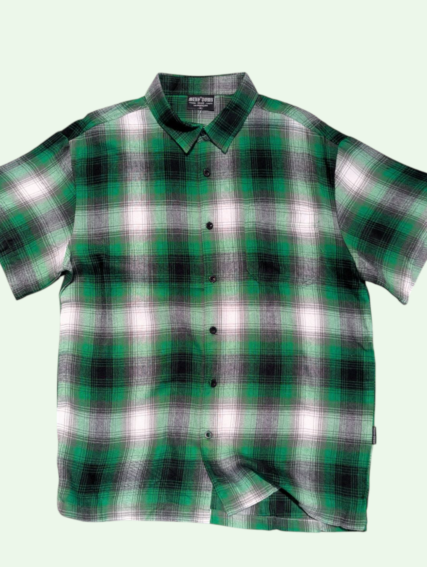 a flatlay of the plaid dad button up shirt