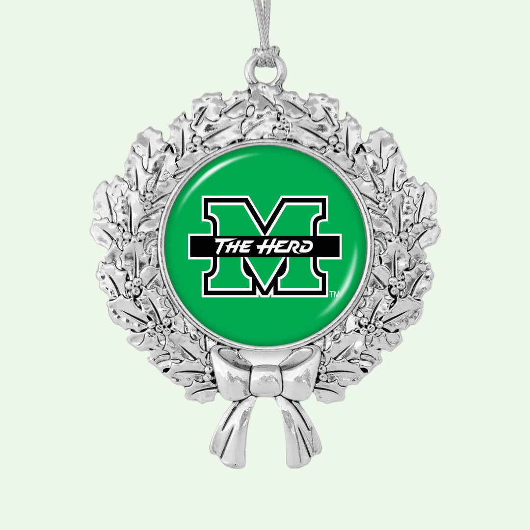 Decorative ornament with green center and silver wreath on a white background