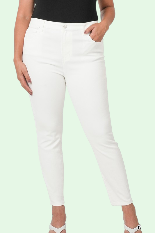 White pants worn by a person on a light green background