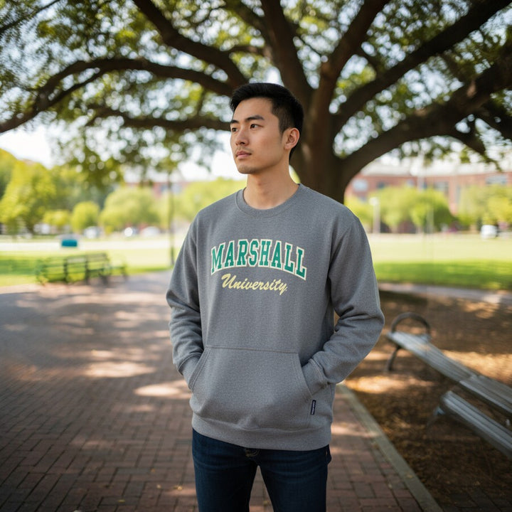 Person wearing a gray 'Marshall University' sweatshirt on a campus path.