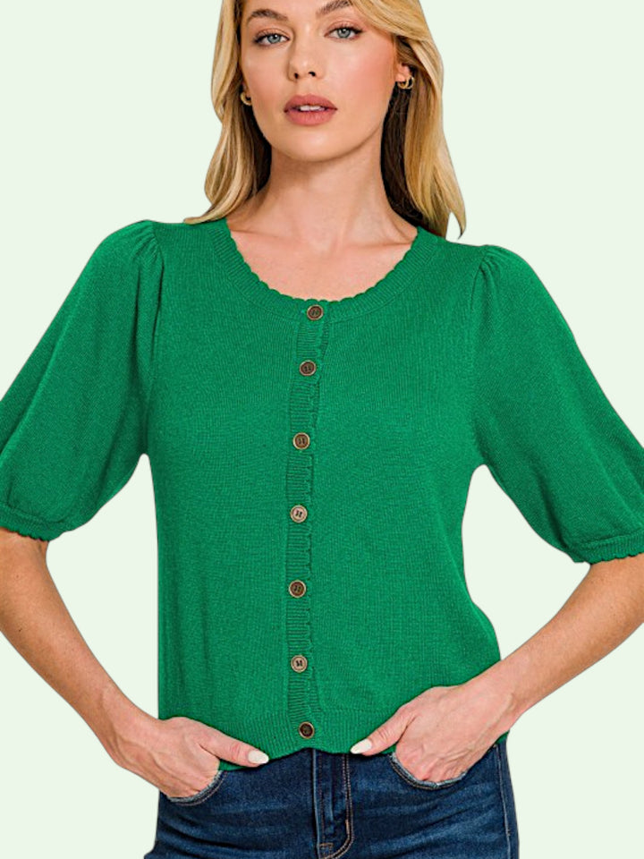 Woman wearing a green button-up shirt with a plain background