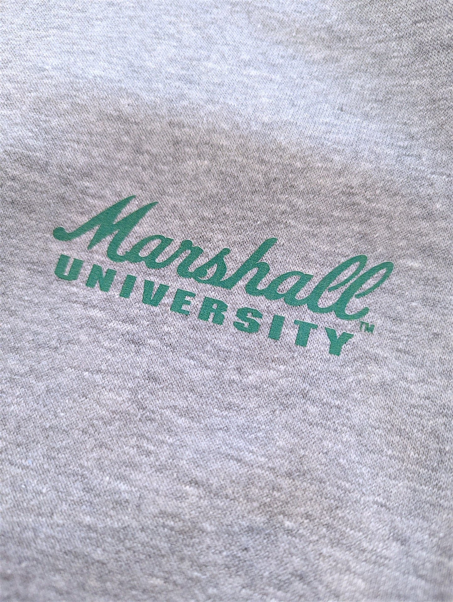 Gray sweatshirt with 'Marshall University' printed in green on a close-up view