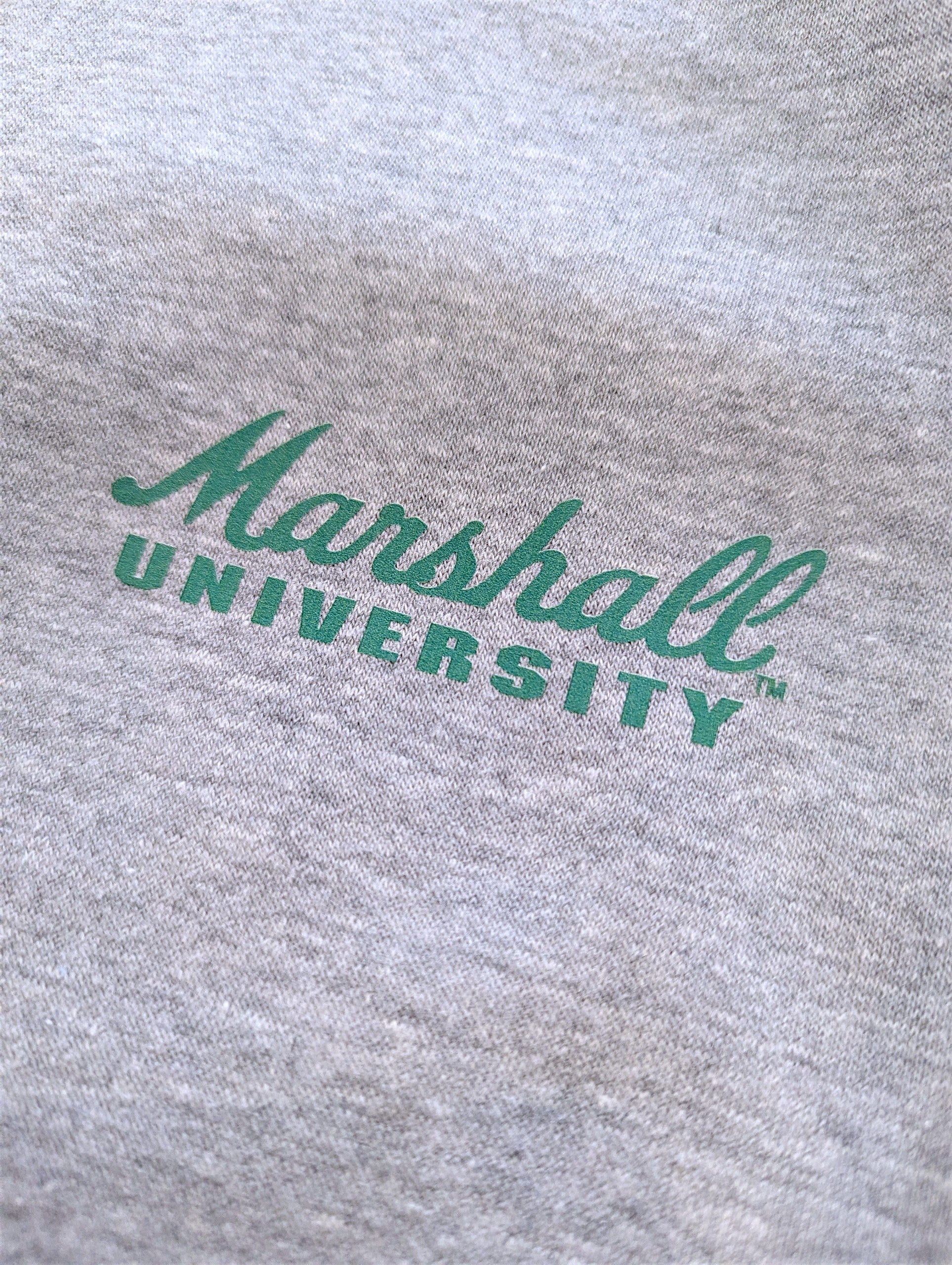 Gray sweatshirt with 'Marshall University' printed in green on a close-up view