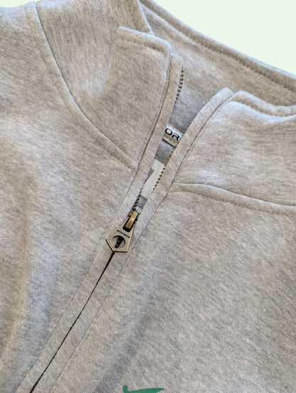 Close-up of a gray fleece jacket with a zipper on a white background