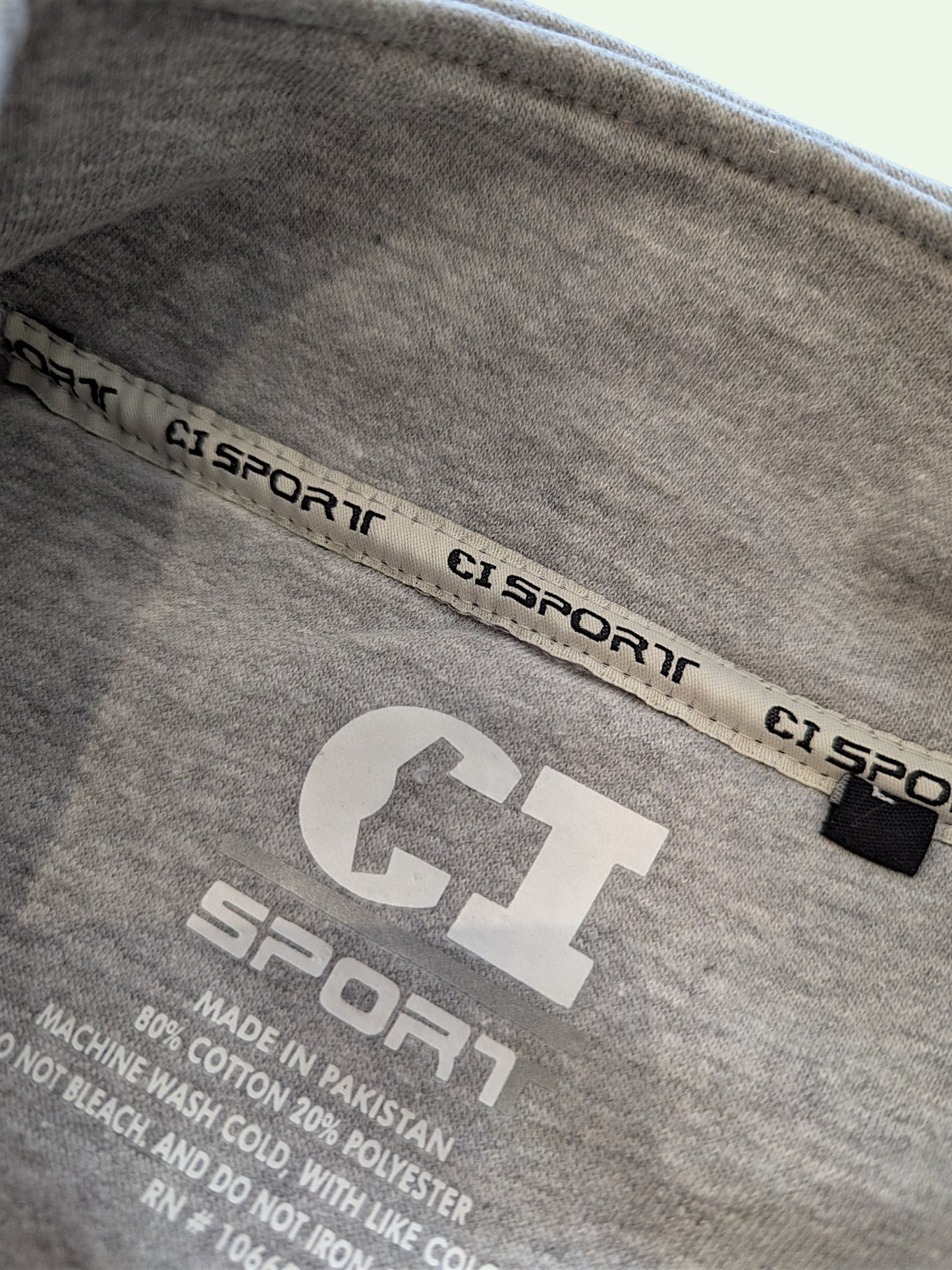 Gray t-shirt with CI Sport branding and label details.
