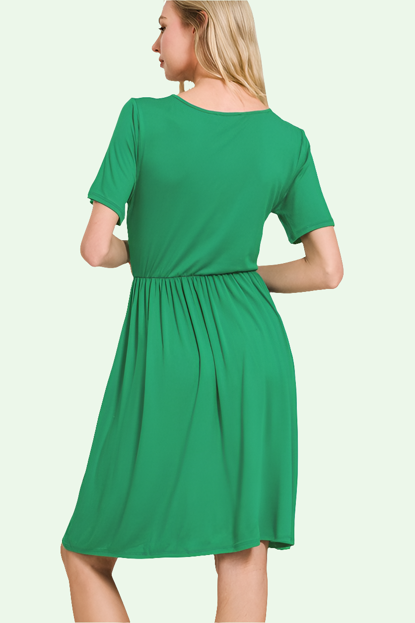 a blonde model stands with her back to the camera showing the back of the rebecca dress