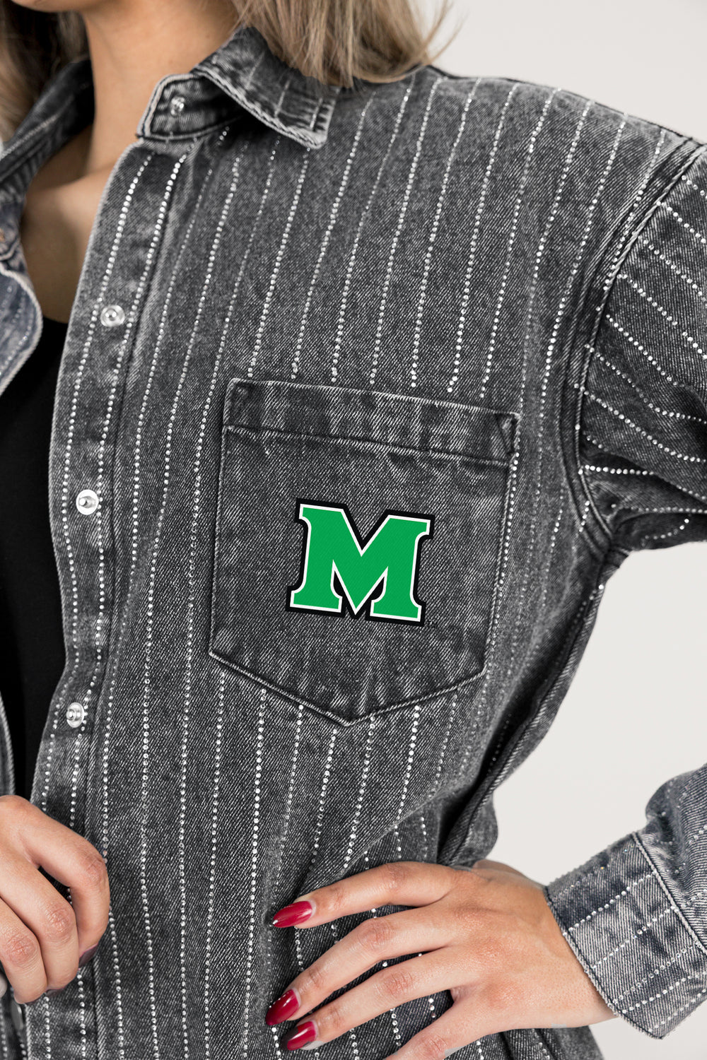 Person wearing a gray pinstripe shirt with a green 'M' logo on a white background