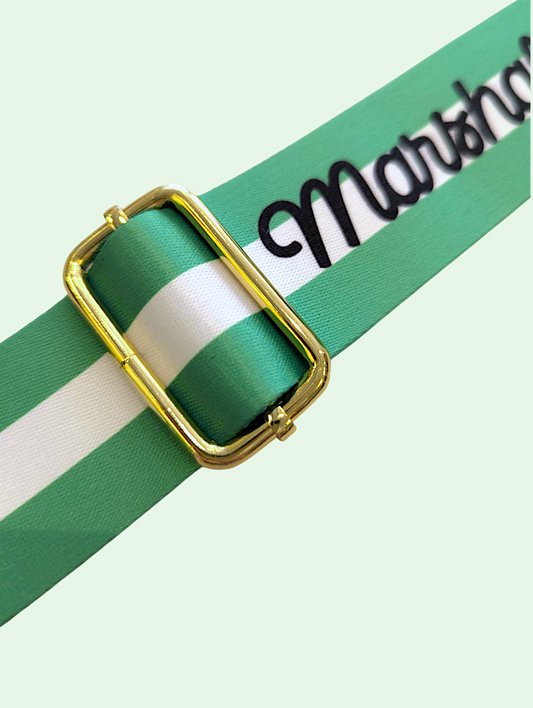 Green and white striped ribbon with gold buckle on a light green background