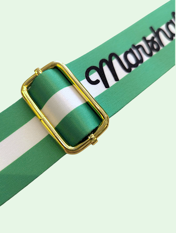 Green and white striped ribbon with gold buckle on a light green background