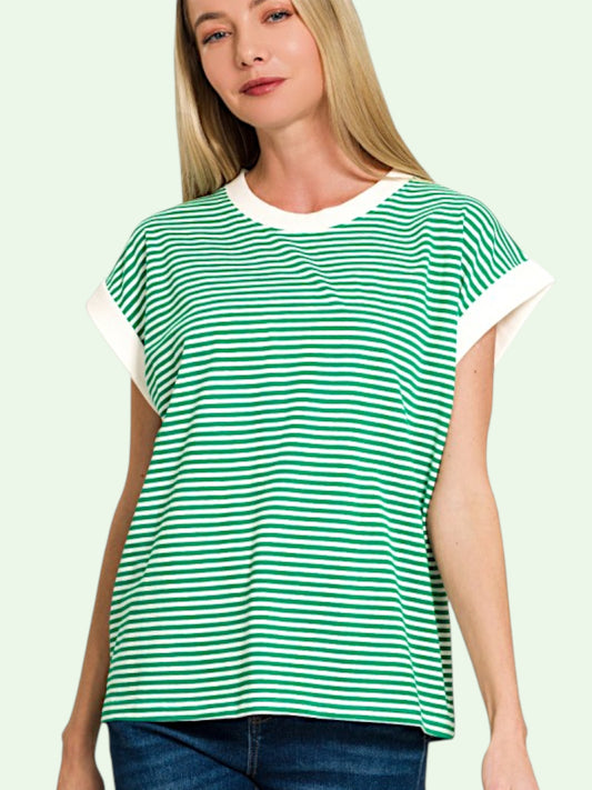 Woman wearing a green and white striped shirt on a light green background