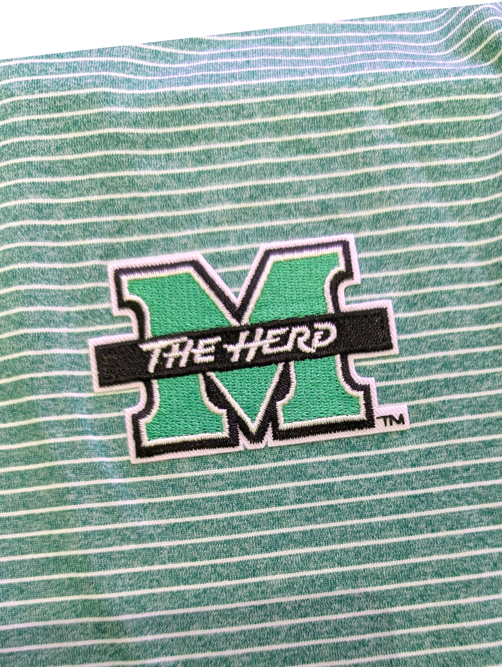 Green and white striped fabric with 'The Herd' logo