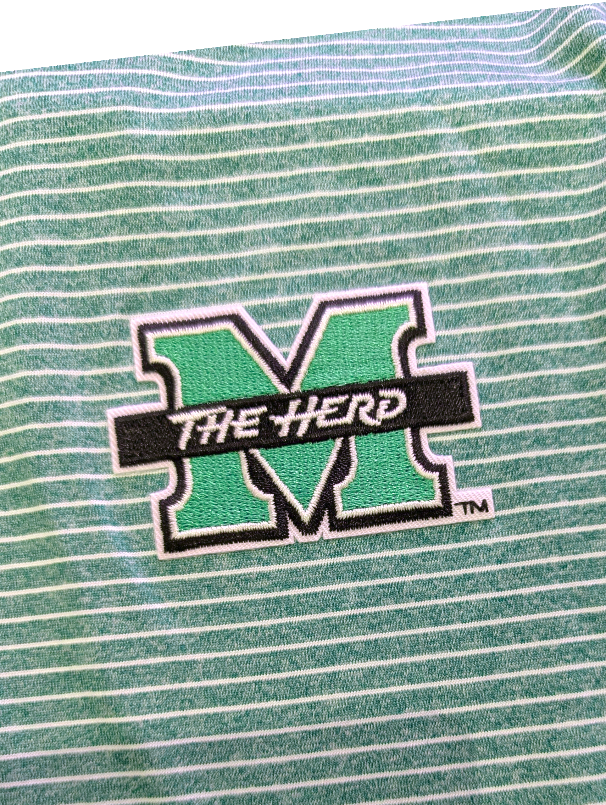 Green and white striped fabric with 'The Herd' logo