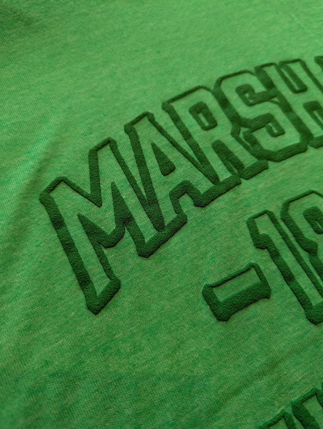 Green t-shirt with 'MARSH' and number '18' printed on it