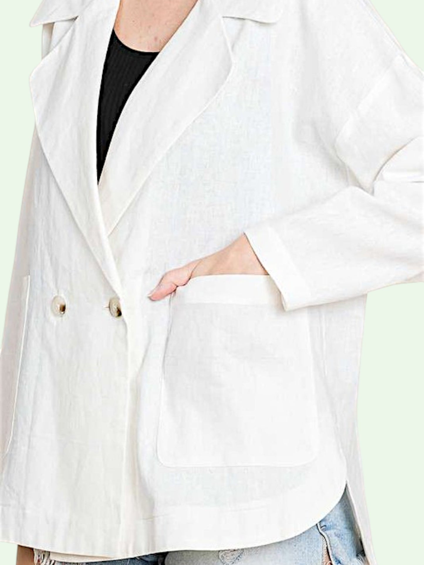 White blazer worn by a person with a blurred background