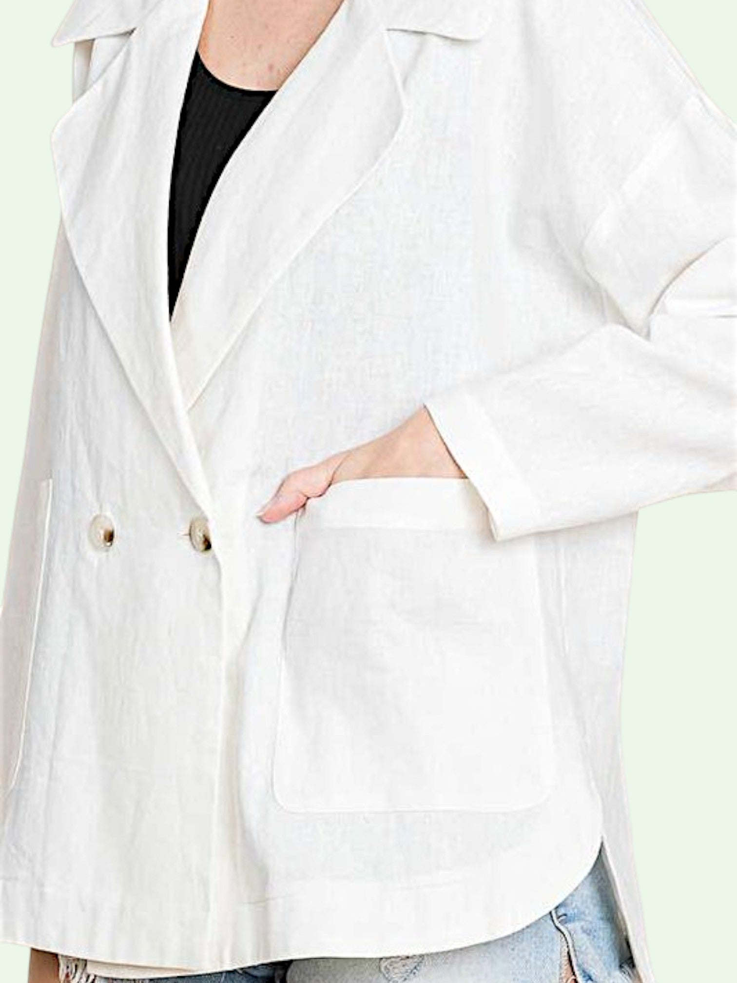 White blazer worn by a person with a blurred background
