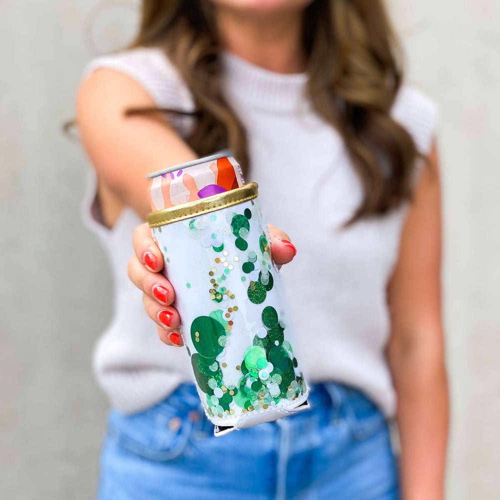 Person holding a decorated can with green pattern and colorful top
