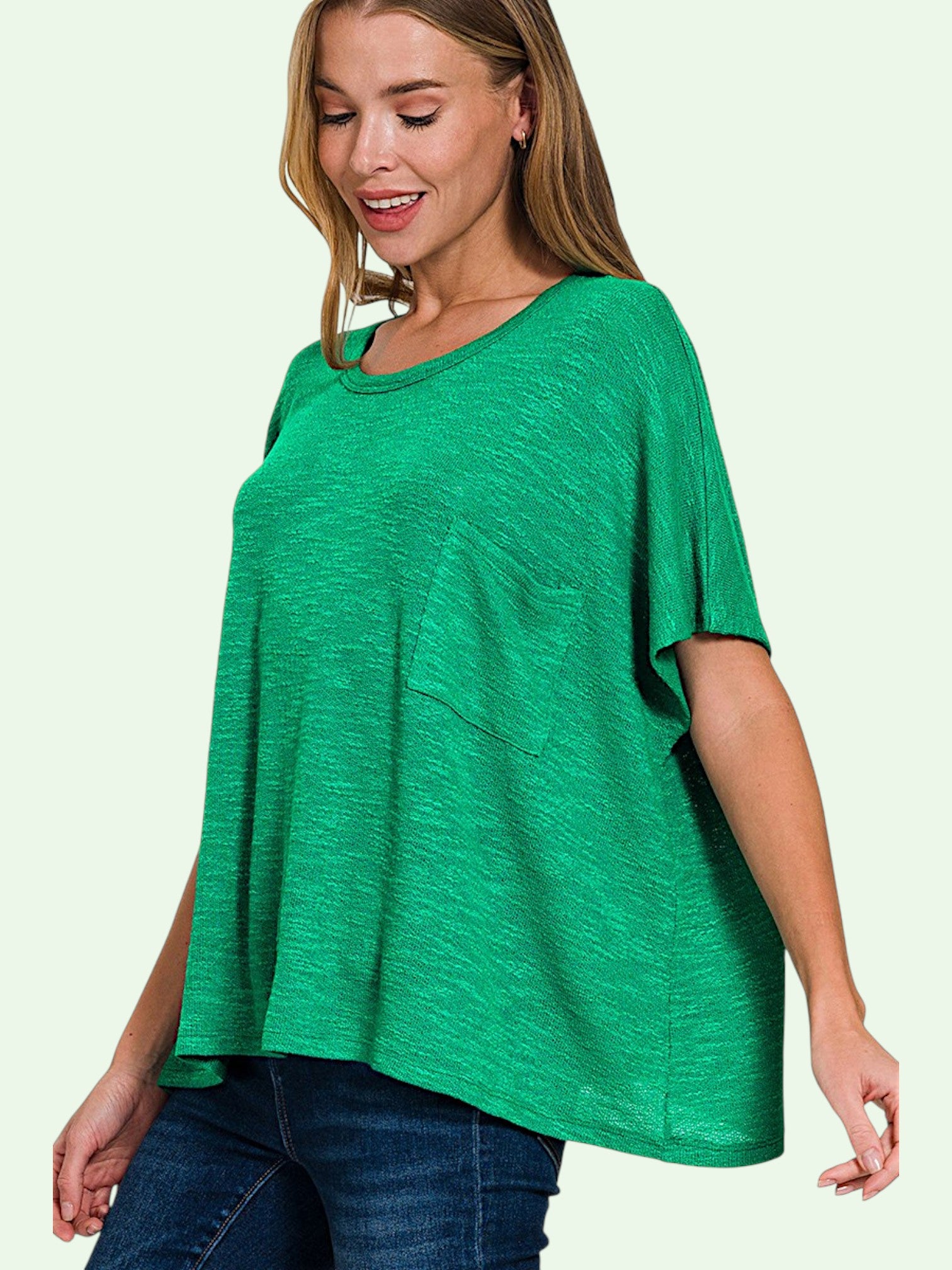 Woman wearing a green oversized shirt on a light green background