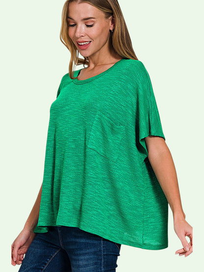 Woman wearing a green oversized shirt on a light green background