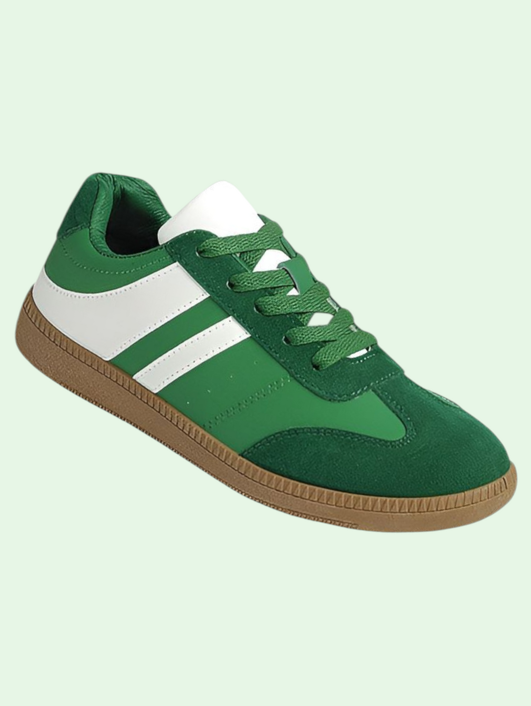 Green sneaker with white stripe on a light green background