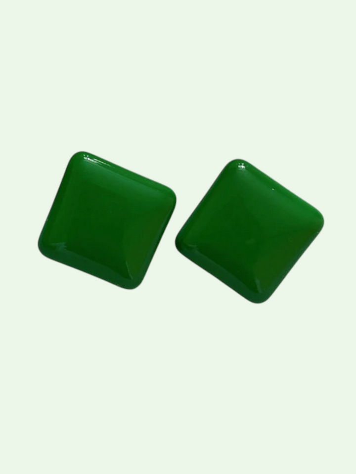 Two green square beads on a light green background