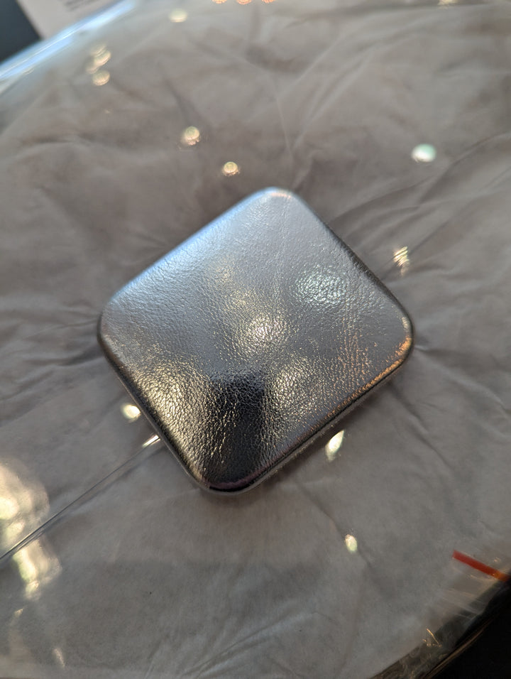 close up of the silver fastener on the clutch