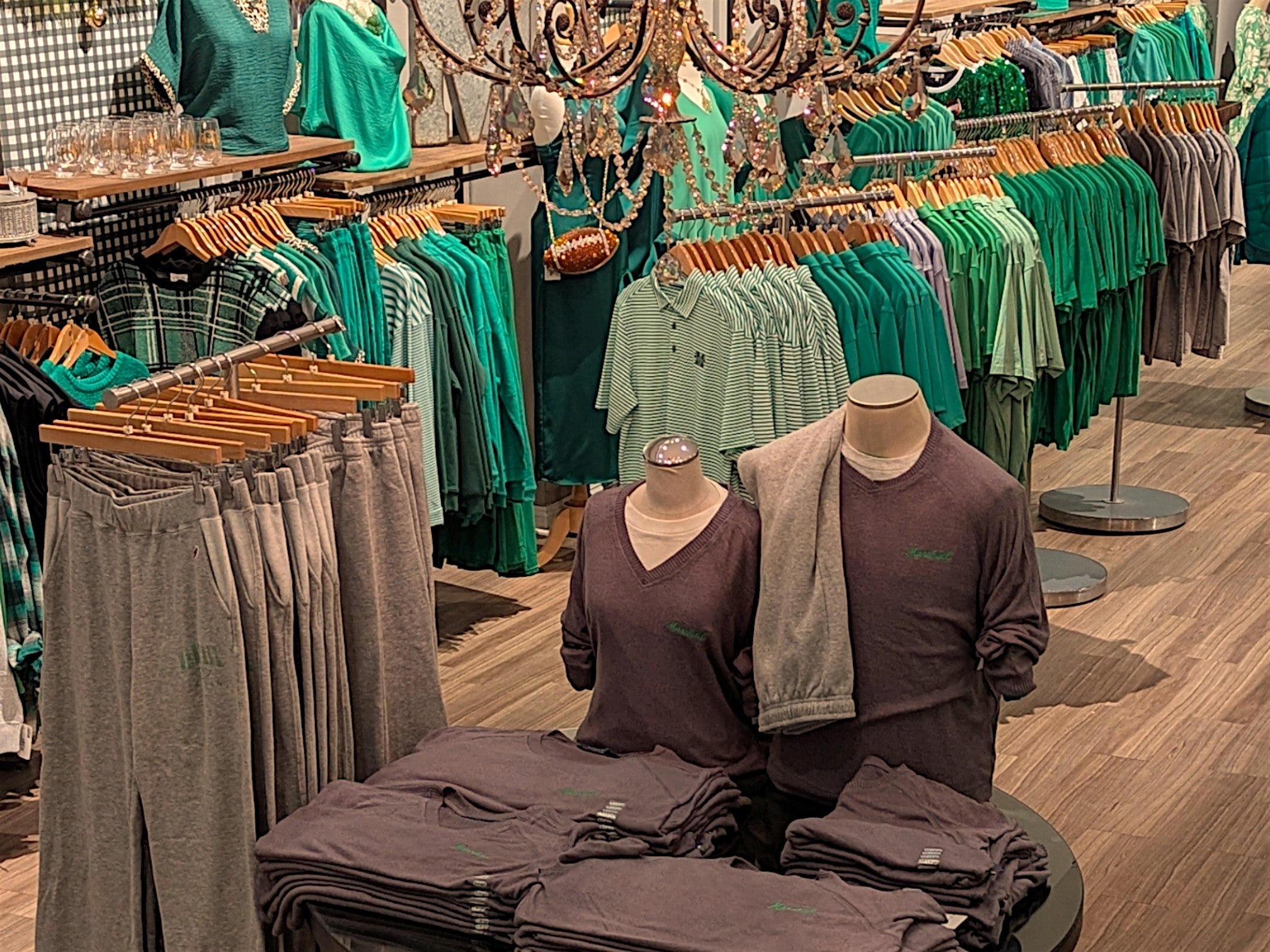 OME interior with racks of shirts and pants, mannequins, and jewelry.