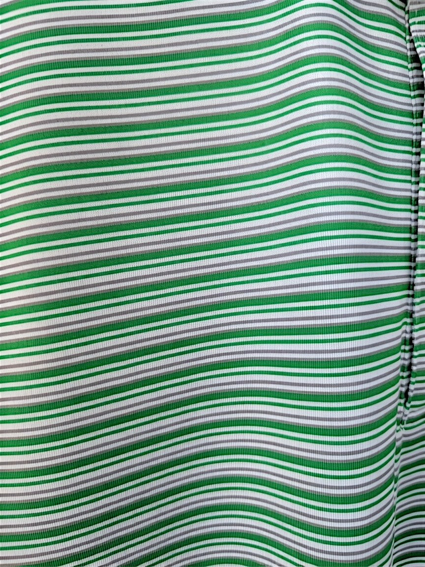 Close-up of a green and white horizontally striped fabric with a gathered side seam.