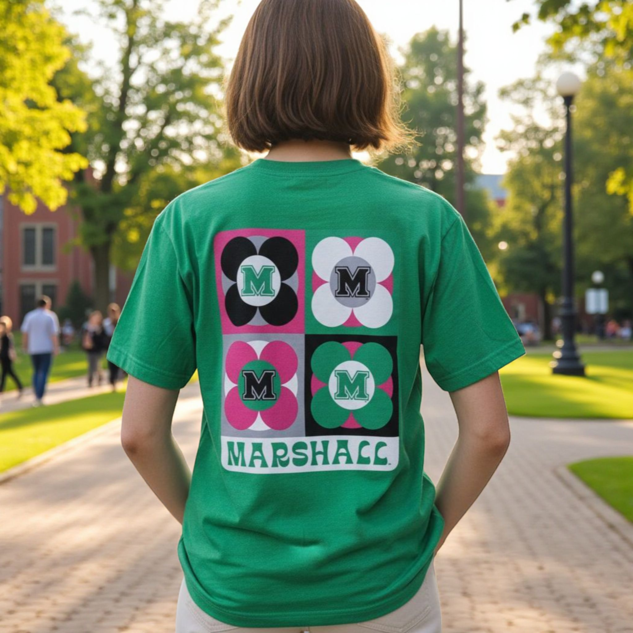 Person wearing a green t-shirt with decorative patterns and 'Marshall' text on the back, standing outdoors.