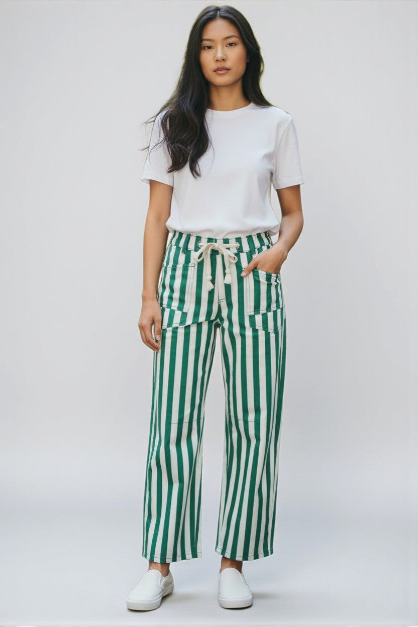 Person wearing a white t-shirt and green striped pants on a white background