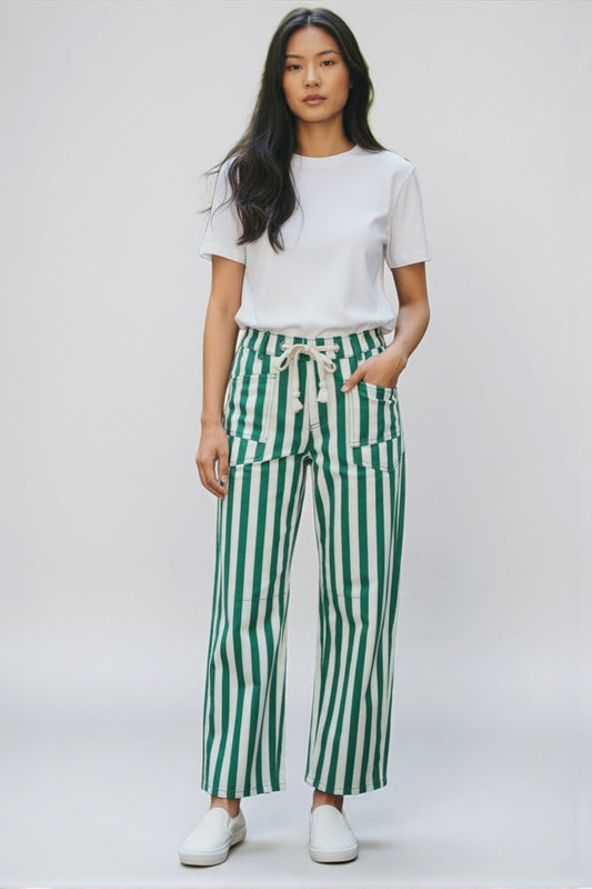Person wearing a white t-shirt and green striped pants on a white background
