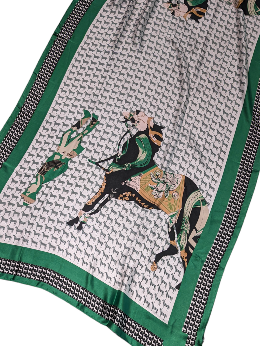 detail of the scarf, featuring a multicolor horse and upside down jockey, surrounded with a repeat print of tiny horses