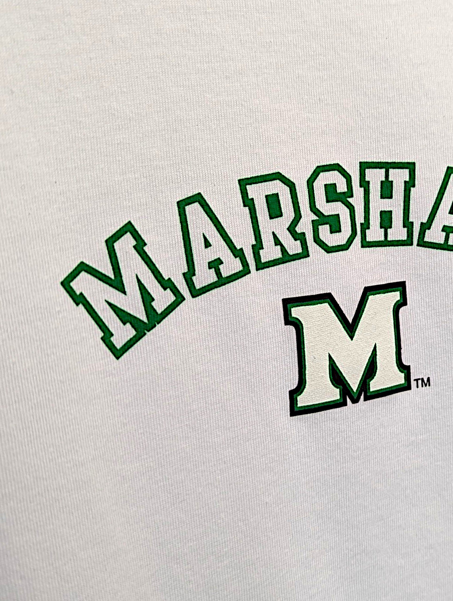Close-up of a white t-shirt featuring green varsity-style lettering that reads 'MARSH...' with a large outlined 'M' below it.