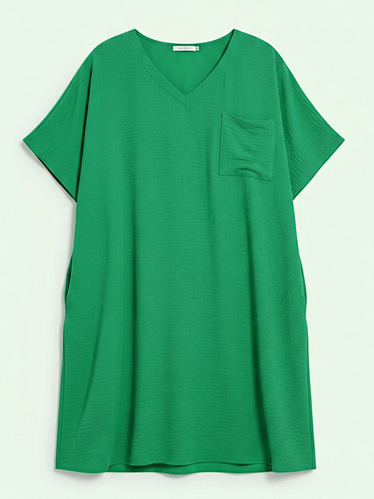 Green tunic with a pocket on a light gray background
