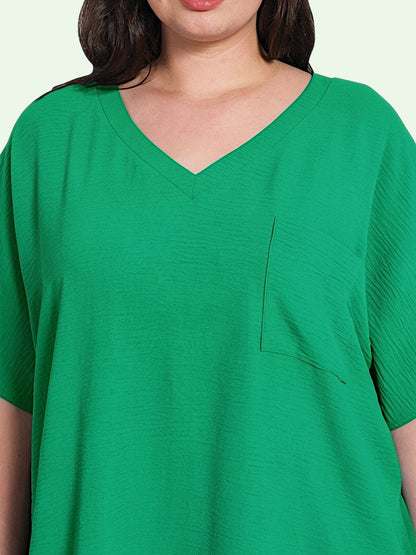 Green V-neck t-shirt with a pocket on a light green background