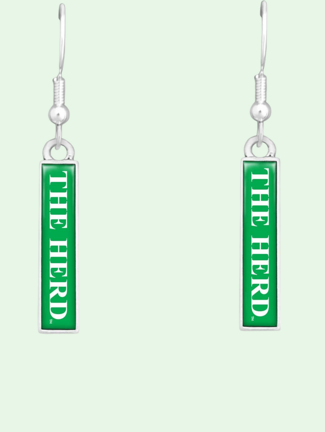 Green 'THE HERD' earrings on a light green background