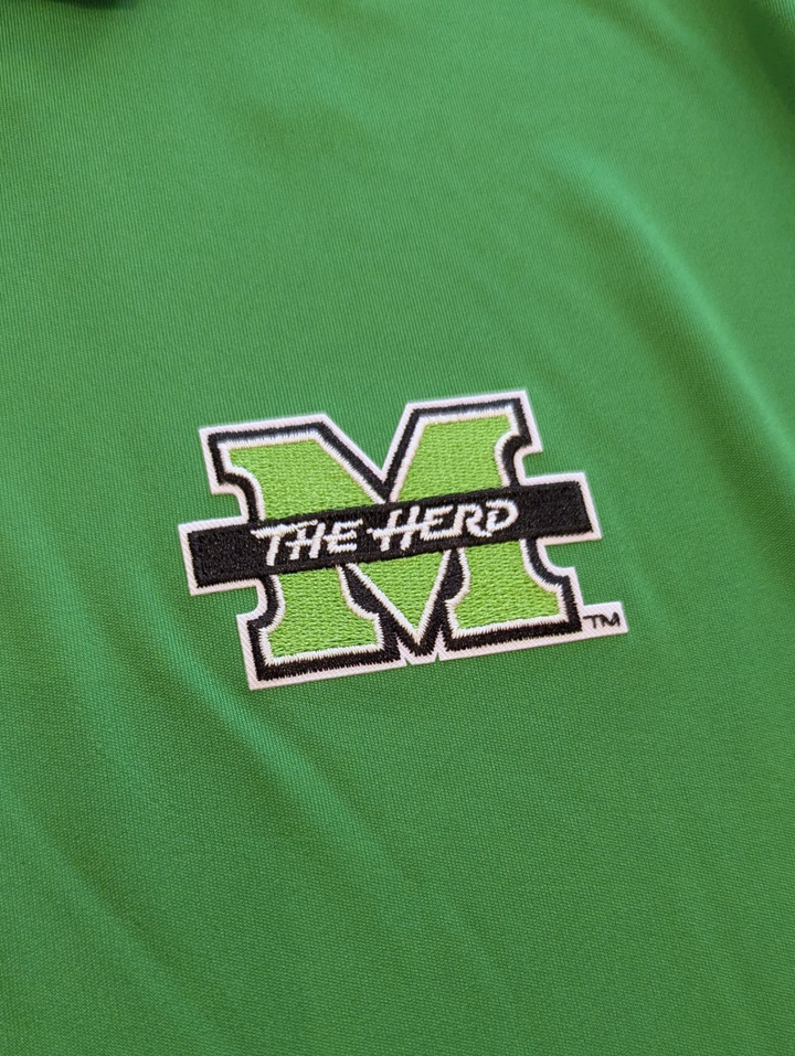 Green shirt with 'The Herd' logo on a green background