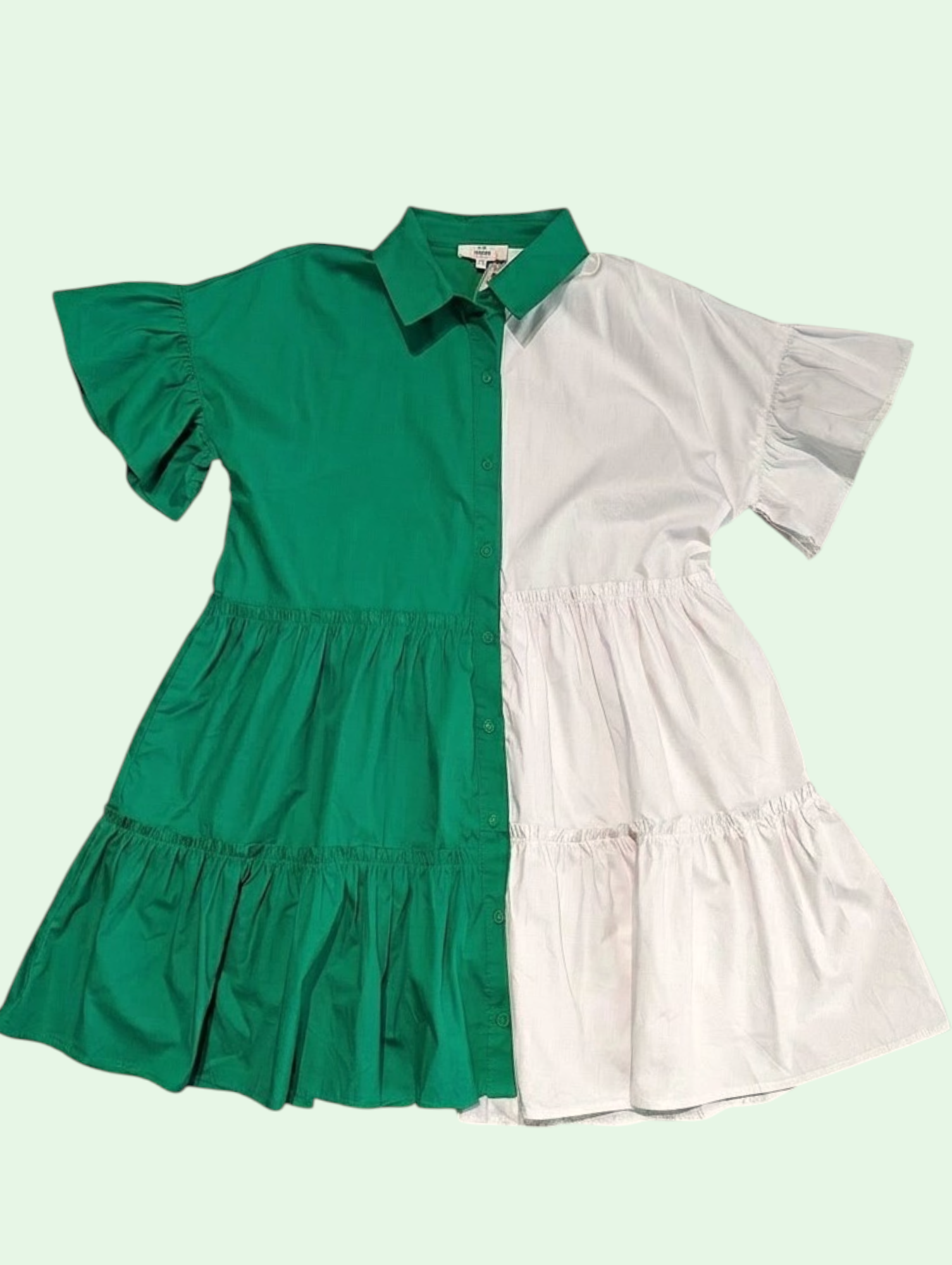 Green and white dress with ruffled sleeves on a light green background