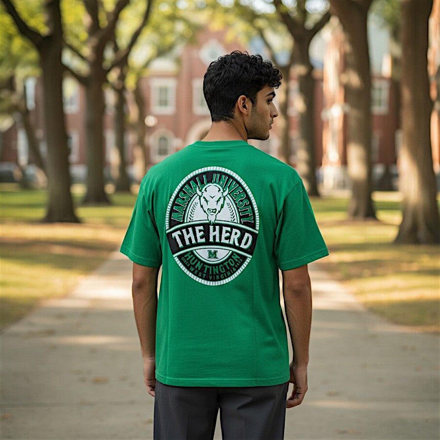 Person wearing a green t-shirt with 'The Herd' logo on a college campus