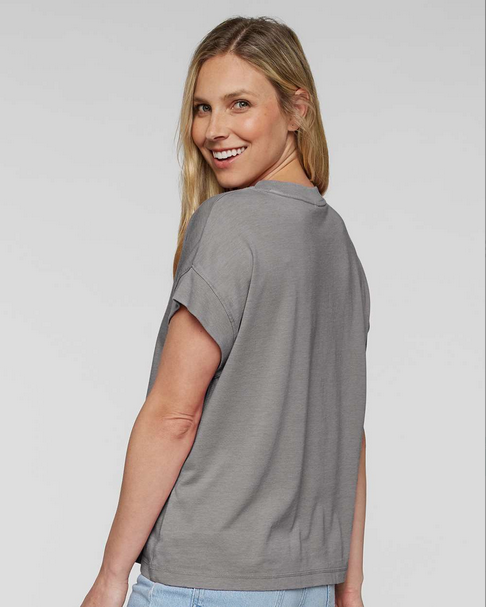 Woman wearing a gray t-shirt against a plain background
